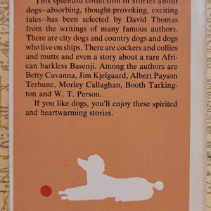 May include: A vintage paperback book cover with an orange background and a white silhouette of a dog. The book title is "Dog Stories" and the text reads "Dedicated to man's best friend".