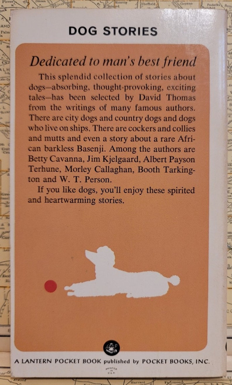 May include: A vintage paperback book cover with an orange background and a white silhouette of a dog. The book title is "Dog Stories" and the text reads "Dedicated to man's best friend".
