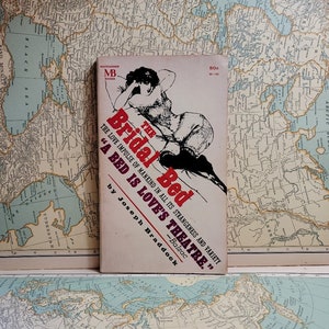 May include: A vintage paperback book cover with a red background and a woman in a white dress and black stockings. The title of the book is "The Bridal Bed" and the subtitle is "The Love Impulse of Mankind in All Its Strangeness and Variety." The quote "A Bed Is Love's Theatre." by Balzac is also included.