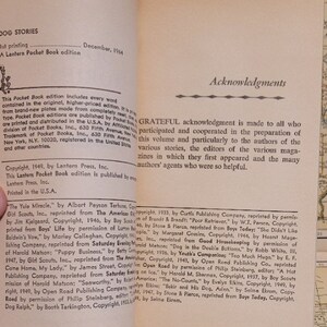 May include: A book titled "Dog Stories" with a copyright date of December 1964. The book cover features a black and white illustration of a dog with a red collar. The book includes a list of stories and their authors, including "The Yule Miracle" by Albert Payson Terhune, "Baldwin's Vow" by Morley Callaghan, and "Puppy Business" by Batty Archer.