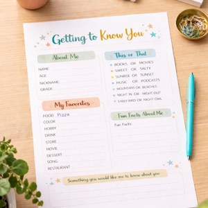 May include: A printed 'Getting to Know You' questionnaire on a wooden surface. The form includes sections for 'About Me,' 'My Favorites,' 'This or That,' and 'Fun Facts.' A teal pen and a small bowl with paper clips are also visible.
