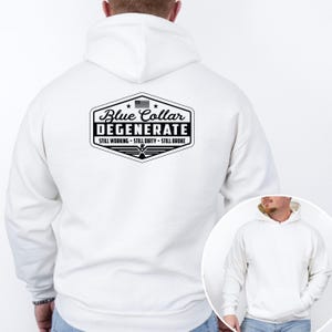 May include: White hooded sweatshirt with a front pocket and a drawstring hood. The back features a black and white graphic with the text "Blue Collar Degenerate" and the phrases "Still Working, Still Dirty, Still Broke."