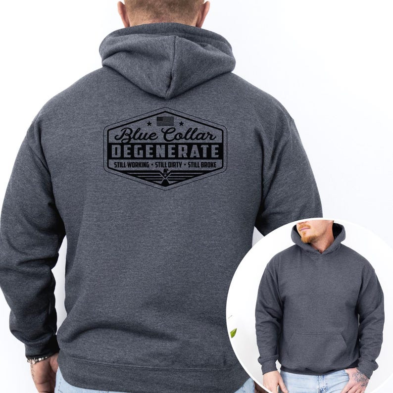 May include: A dark gray hoodie with a drawstring hood and a front pocket. The back of the hoodie features a black graphic that reads "Blue Collar Degenerate" with the phrases "Still Working, Still Dirty, Still Broke."