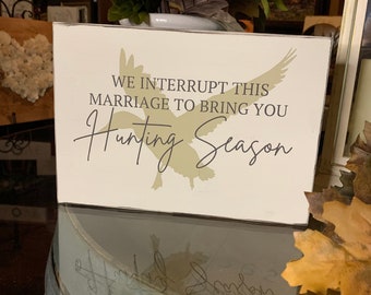Perfect Duck Hunter’s Sign, “We Interrupt This Marriage to Bring You Hunting Season”.  Funny gift for Hunter and his wife or her husband.