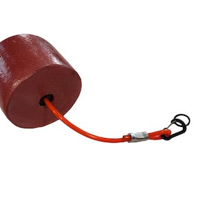 May include: A red cylindrical buoy with an orange cord attached to a black carabiner clip.