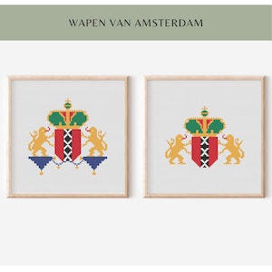 May include: Two framed prints of the Amsterdam coat of arms. Each print shows a red shield with three white crosses, a green and gold crown, and two gold lions. The text "WAPEN VAN AMSTERDAM" is above the prints.