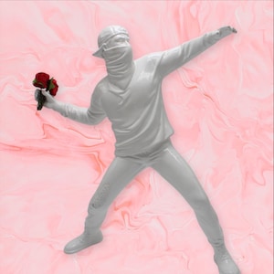 May include: A white sculpture of a figure in a baseball cap and face covering, holding a bouquet of red roses, in a throwing pose. The figure is on a pink and white marbled background.
