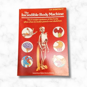 May include: A red book titled "The Incredible Body Machine" with a picture of a skeleton and illustrations of the six major systems of the body. The book includes a fun-to-make punch-out skeleton.