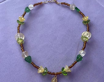Our Lady’s garden - yellow, brown, and green floral beaded wire miraculous medal necklace - gold tone