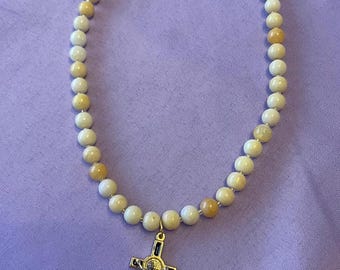 Yellow/white beaded wire necklace with black and gold tone crucifix