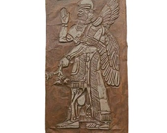 May include: A brown clay relief sculpture of a winged figure with a crown and a staff. The figure is wearing a long robe and has a beard. The sculpture is set against a brown background.