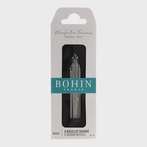 May include: A package of Bohin France sashiko needles. The white and gray package features the text "Manufacture Française Depuis 1833" and "BOHIN FRANCE". The package contains 8 sashiko needles.