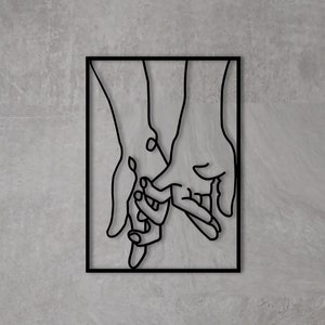 May include: Black metal wall art depicting two hands holding each other. The hands are outlined in a simple, minimalist style.