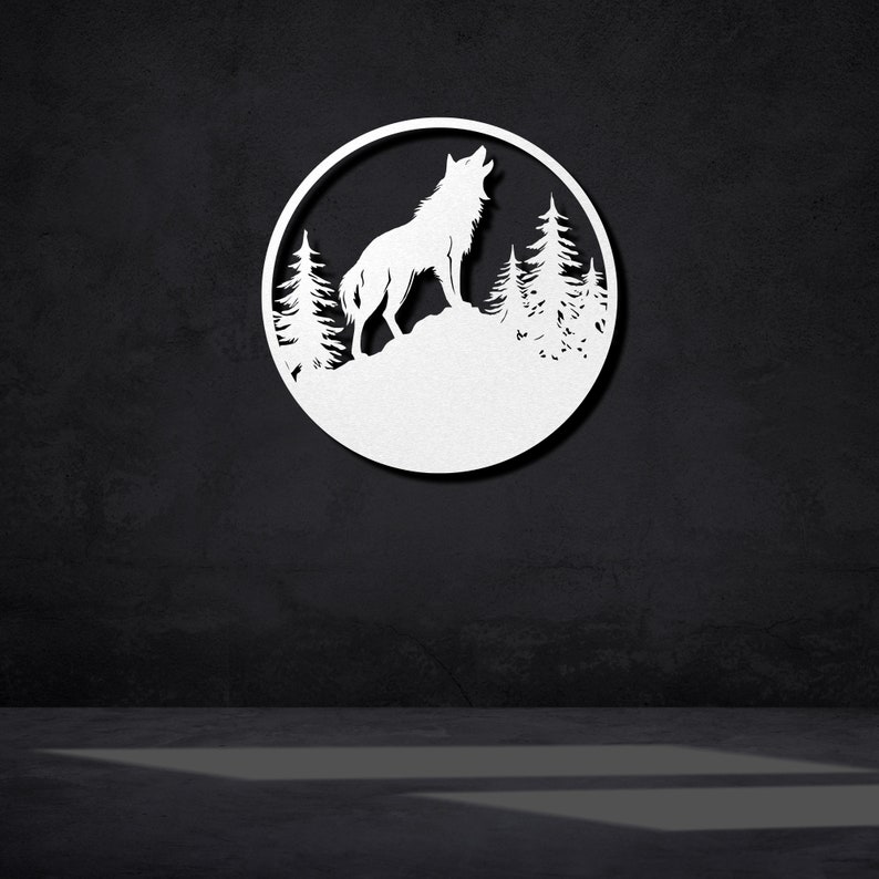 May include: White metal wall art featuring a wolf howling at the moon with a forest silhouette in the background.