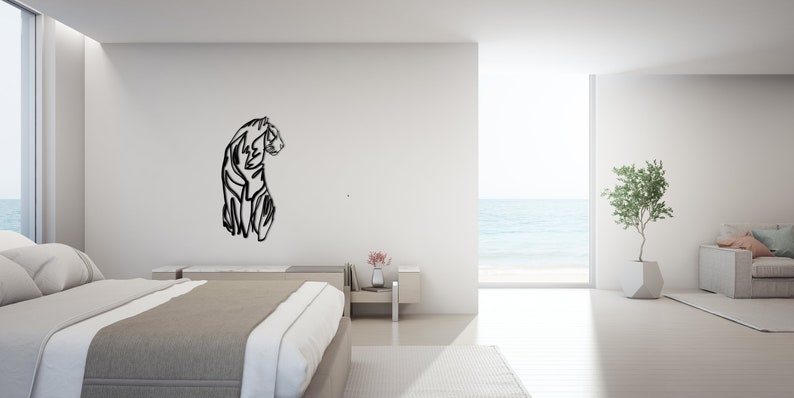 May include: A black and white line art illustration of a tiger on a white wall in a modern bedroom with a bed, a side table, and a window with a view of the sea.