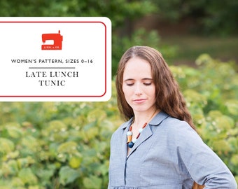 May include: A blue tunic with a white collar and a gathered waist. The tunic is made of a lightweight fabric and has a relaxed fit. The text "Late Lunch Tunic" is printed on a red label.