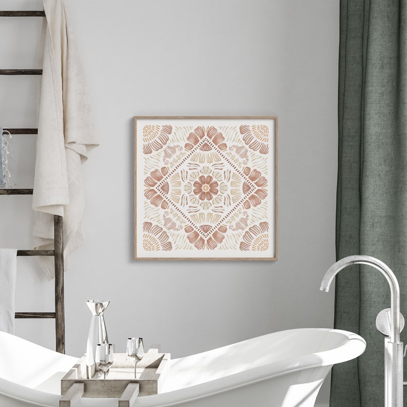 May include: A framed print of a geometric design with a mandala-like pattern in shades of brown and beige. The design features intricate floral motifs and a central flower.