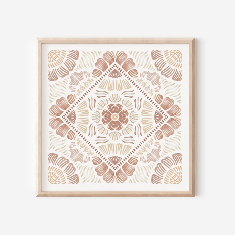 May include: A framed print with a geometric pattern in shades of brown and beige. The pattern features a central flower with four petals and is surrounded by smaller flowers and geometric shapes.