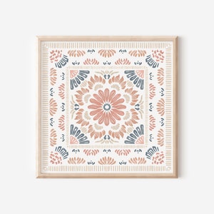 May include: A framed print with a geometric pattern in shades of pink, brown, and blue. The pattern features a central flower motif surrounded by repeating shapes.