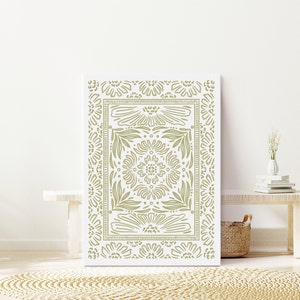 May include: A white canvas print with a green floral pattern. The pattern is symmetrical and features a repeating design of flowers and leaves.