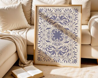 May include: A framed print with a white background and a blue floral pattern. The pattern is symmetrical and features a large flower in the center.