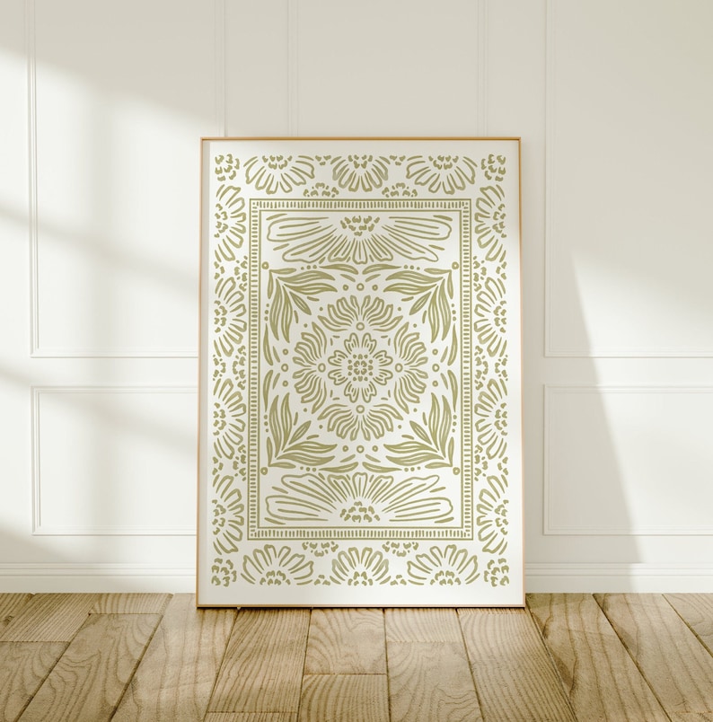 May include: A framed print with a green floral pattern on a white background. The pattern is a repeating design of stylized flowers and leaves.