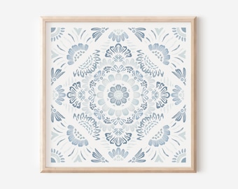 May include: A framed print with a blue and white mandala design. The mandala is made up of intricate floral patterns and is surrounded by a border of smaller floral motifs.