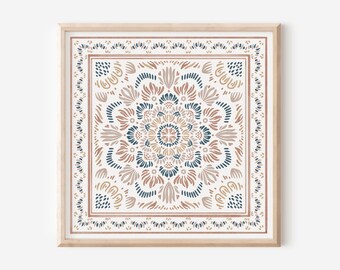 May include: A framed print with a white background and a colorful mandala design in shades of brown, pink, and blue. The mandala is surrounded by a border of smaller floral motifs.