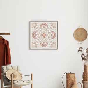 May include: A framed print with a geometric design in shades of brown and beige. The design features a central flower motif surrounded by repeating patterns.