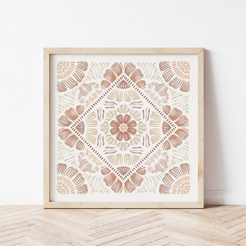 May include: A framed print with a geometric pattern in shades of brown and beige. The pattern features stylized flowers and leaves, creating a symmetrical design.