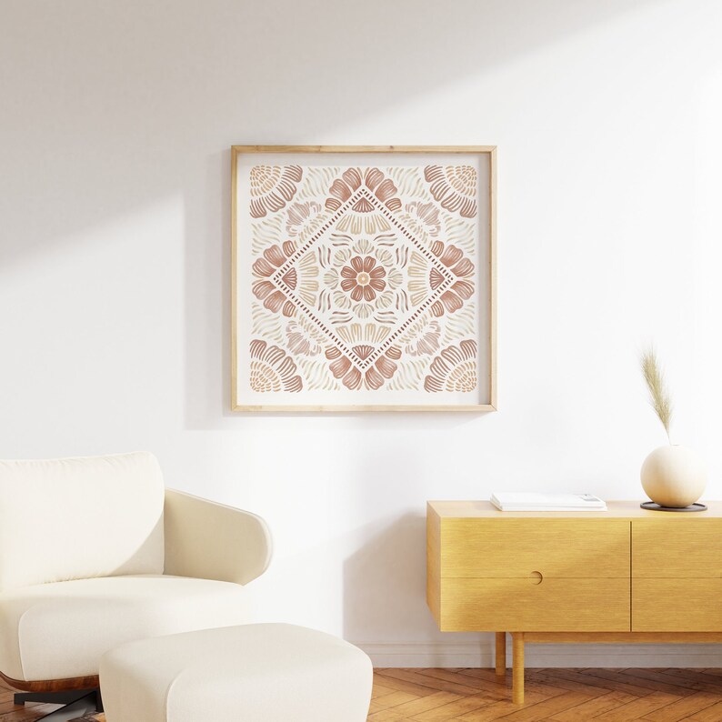 May include: A framed print with a geometric pattern in shades of brown and beige. The pattern is a symmetrical design of overlapping flower shapes.