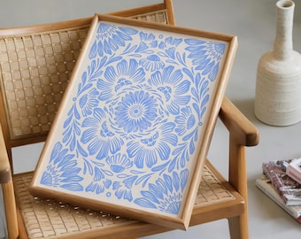 May include: A rectangular wooden tray with a light blue floral design on a cream background. The tray is resting on a wooden chair with a woven seat. A white vase and books are in the background.