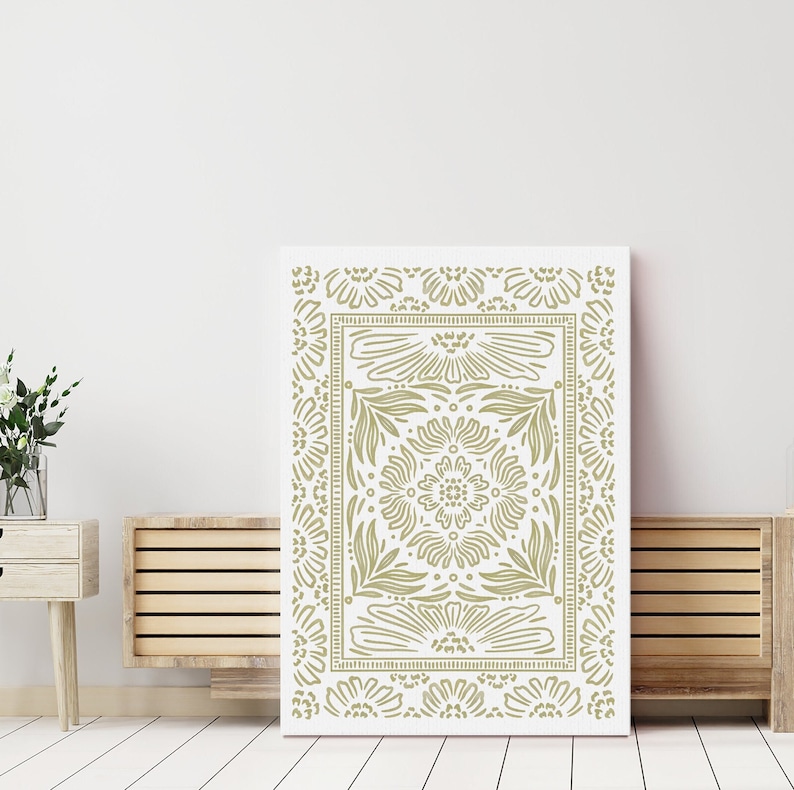 May include: A white canvas print with a gold floral pattern. The pattern is a repeating design of stylized flowers and leaves.