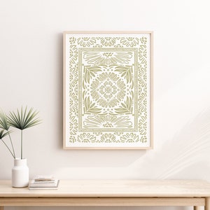 May include: A framed print with a green floral pattern. The pattern is a repeating design of flowers and leaves, creating a symmetrical design.