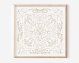 May include: A framed print with a beige floral pattern on a white background. The pattern is symmetrical and features a large central flower with smaller flowers surrounding it.
