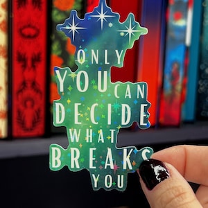 May include: A holographic sticker with a green and blue background and white stars. The sticker says "Only you can decide what breaks you."