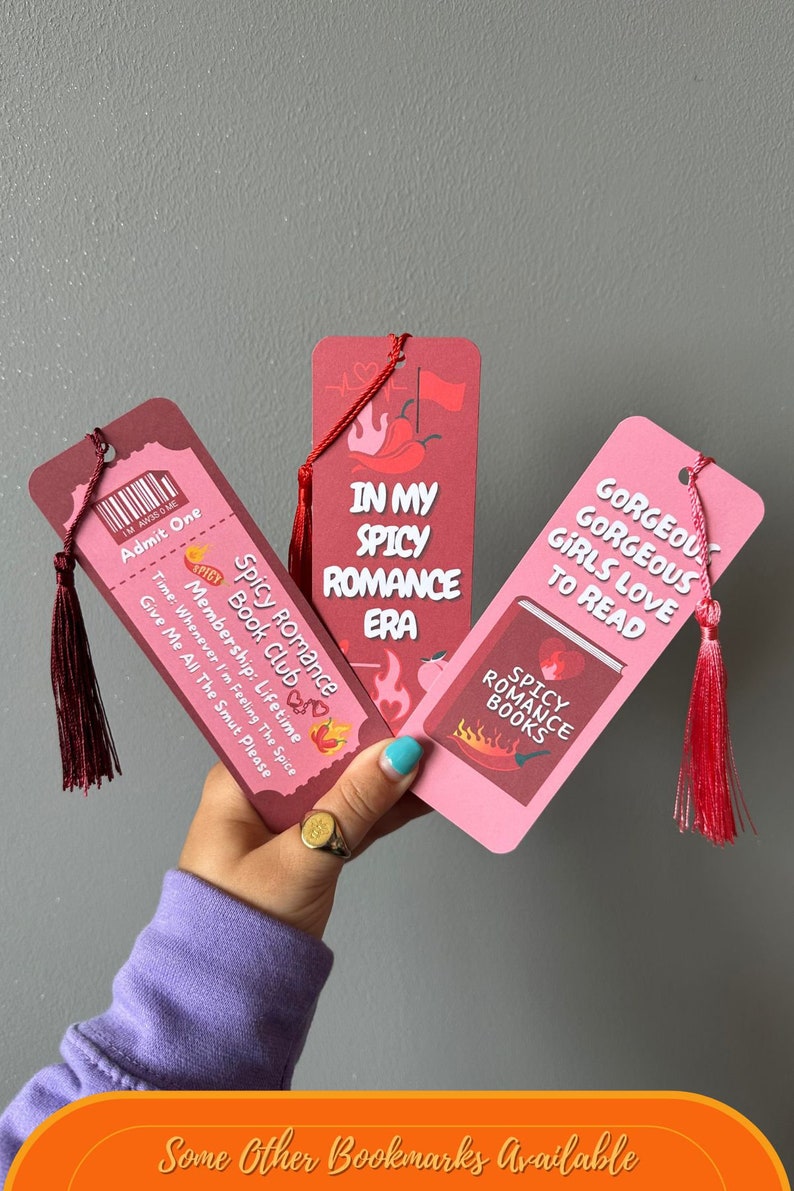 May include: Three pink and red bookmarks with red tassels. The bookmarks feature text that says "Spicy Romance Book Club", "In My Spicy Romance Era", and "Gorgeous Girls Love To Read".