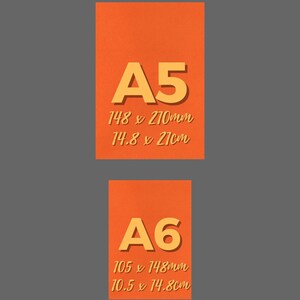 May include: Two orange A5 and A6 paper sheets with dimensions in millimeters and centimeters. The A5 sheet is 148 x 210mm (14.8 x 21cm), and the A6 sheet is 105 x 148mm (10.5 x 14.8cm).