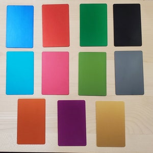 color variations blank side. top left to bottom right is blue, red, emerald green, black, sky blue, pink, light green, grey, orange, purple, and gold.