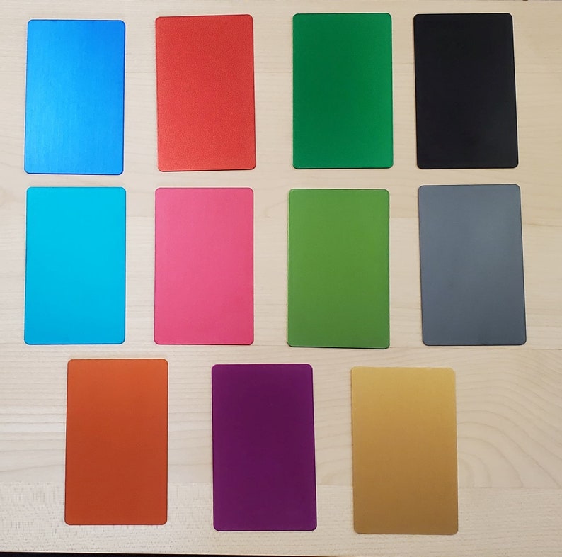 color variations blank side. top left to bottom right is blue, red, emerald green, black, sky blue, pink, light green, grey, orange, purple, and gold.