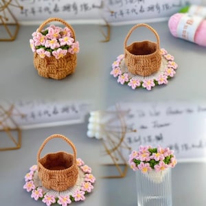 May include: A collection of handmade crochet items. Includes a small brown basket filled with pink flowers, a small basket on a floral doily, and a glass filled with pink flowers. The items are on a light gray surface.