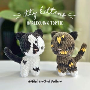 May include: Two small crocheted kittens, one black and white harlequin and one brown and black tortie, with black plastic eyes and pink stitched noses. The text reads: itty kittens HARLEQUIN & TORTIE digital crochet pattern.