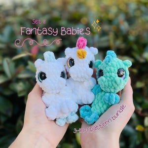 May include: Three handmade crochet fantasy baby creatures in white, turquoise, and seafoam green. The creatures have large, shiny eyes and are held in a person's hands. Text reads "Set 2 Fantasy Babies" and "3-in-1 pattern bundle".
