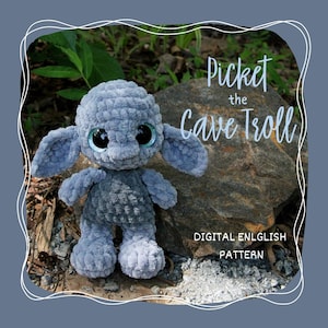 May include: A light grey crochet troll doll with large, glittery eyes and floppy ears. The doll is positioned in front of a rock and foliage. The image includes the text "Picket the Cave Troll" and "DIGITAL ENGLISH PATTERN".