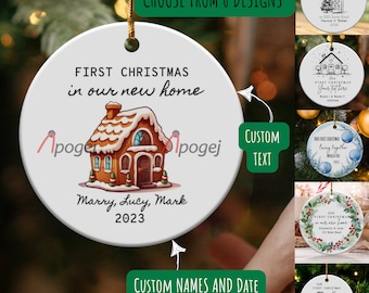 May include: White ceramic Christmas bauble featuring a gingerbread house illustration. The bauble reads "First Christmas in our new home" and includes the names "Marry, Lucy, Mark" and the year "2023".