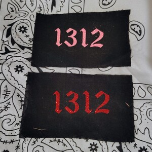 May include: Two black fabric patches with the number "1312" embroidered in pink and red glitter. The number is in a gothic font.
