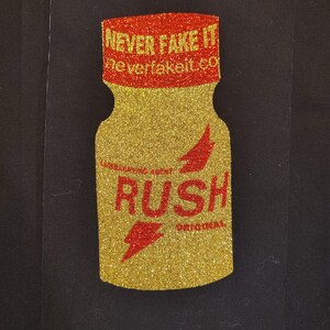 May include: A glittery gold bottle-shaped design with a red cap and accents. The cap reads "NEVER FAKE IT" and the body says "RUSH ORIGINAL" with a red lightning bolt graphic. The website neverfakeit.co is also visible.