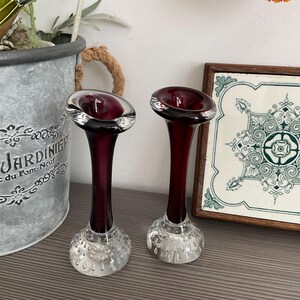 May include: Two vintage glass vases with a deep burgundy stem and a clear, bubble-textured base. The top is a wide, shallow bowl with a silver rim. The vases are approximately 20 cm tall.