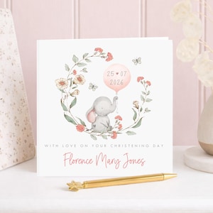 Personalised christening card for baby girl or boy featuring a cute little elephant illustration holding a balloon surrounded by a floral wreath. Perfect keepsake card suitable for christening, baptism, dedication day and more.
Custom name and date, pink or blue options. Printed on quality 300gsm lightly textured cardstock, measures 148 x 148mm and is supplied with a blank recycled kraft envelope.