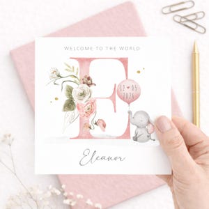Personalised baby girl card with floral letter, elephant illustration, custom newborn name and date, pink welcome to the world card for baby girl